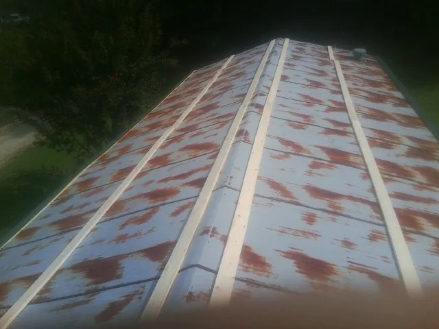 Rusted metal roof panels with new wood purlins before replacement — Storm Damage Roof Repair in Lake Hamilton by Roofing Brothers
